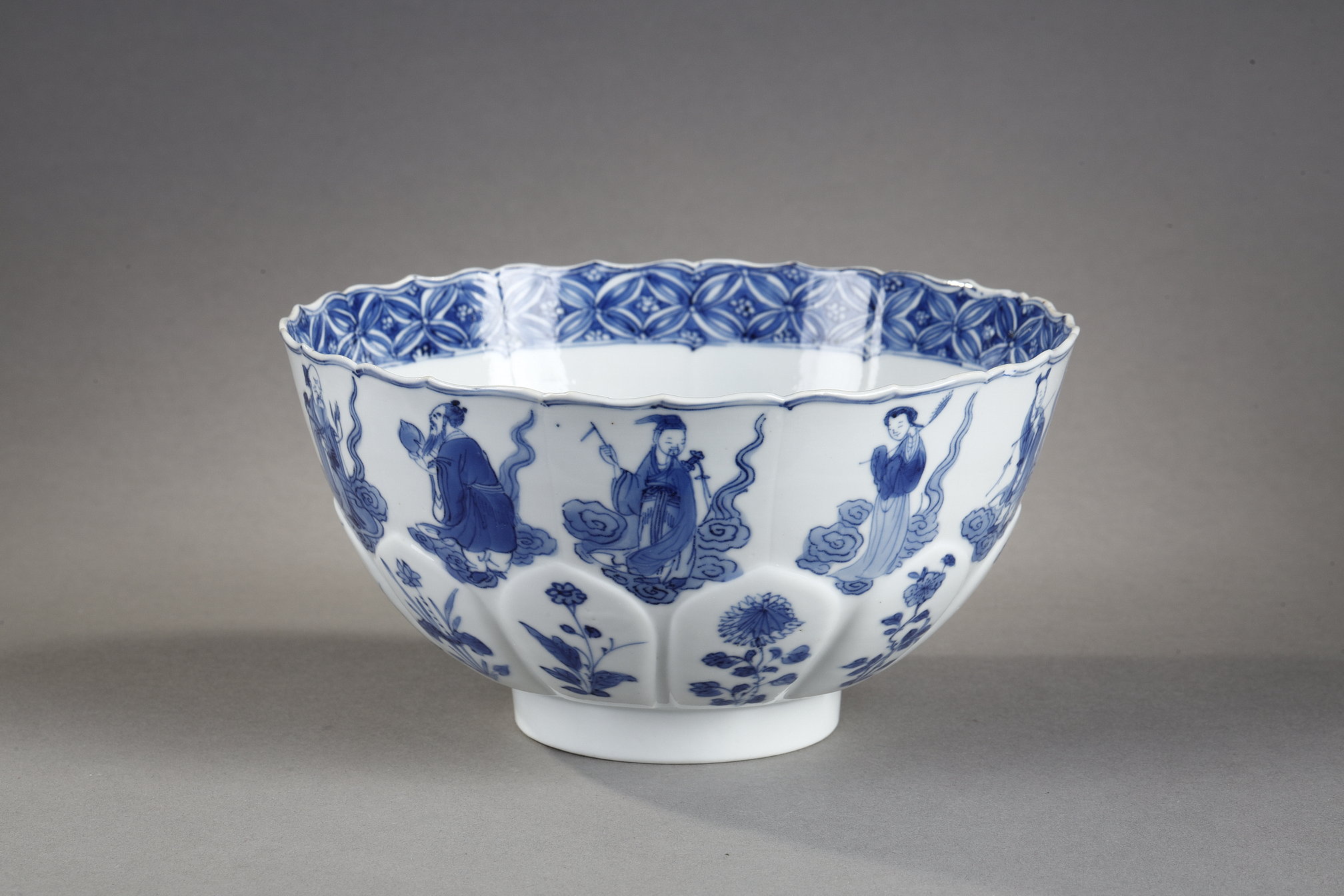 porcelain bowl "blue white" molded in the shape of flower petals and decorated with immortals 
Kangxi mark and period  1662/1722